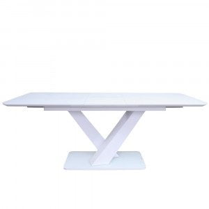 Raztegljiva jedilna miza v beli barvi, s podnožjem v obliki dveh prekrižanih stebrov. Podporni okvir namizja je narejen iz belo lakiranega MDF materiala,