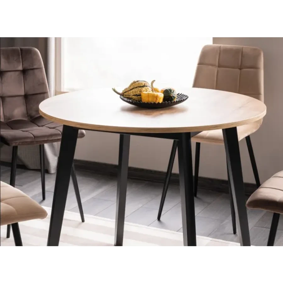 Okrogla jedilna miza VIJOLCA je narejena iz kvalitetne laminirane plošče, ogrodje je iz bukovega lesa. Miza je dobavljiva v barvi hrasta s črnimi mat