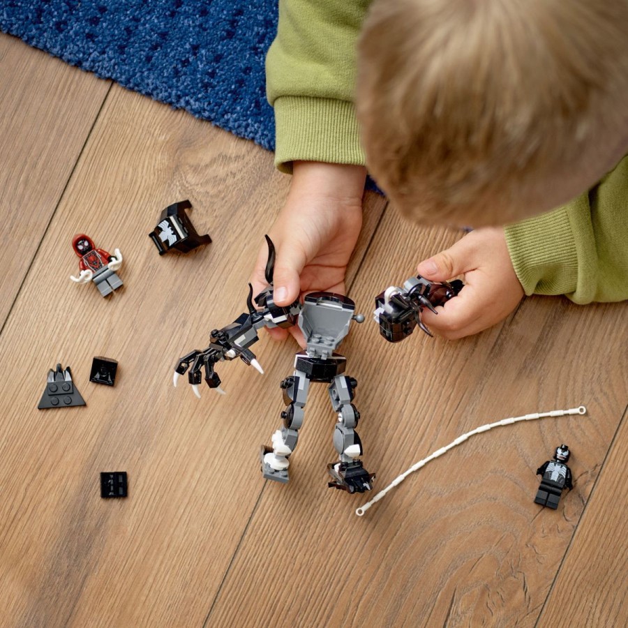 da z gibljivimi rokami zgrabi Milesa. A Miles zaniha na pajčevinasti vrvi okoli robotskega oklepa in že je prost. Spopad Venoma v robotskem oklepu in Milesa Moralesa se nikoli ne konča!