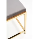 Klop Kira . Klop KIRA je zelo praktična in stabilna. Narejena je iz blaga v sivi barvi, noge pa so iz kromiranega jekla pobarvane v zlato barvo. Dimenzije: -