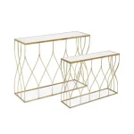 Konzola SET2 ELENOR . Konzola ELENOR je sestavljena iz kovinskega ogrodja, prašno barvanega (zlata barva). Mizna plošča je iz stekla. Dimenzije: širina: